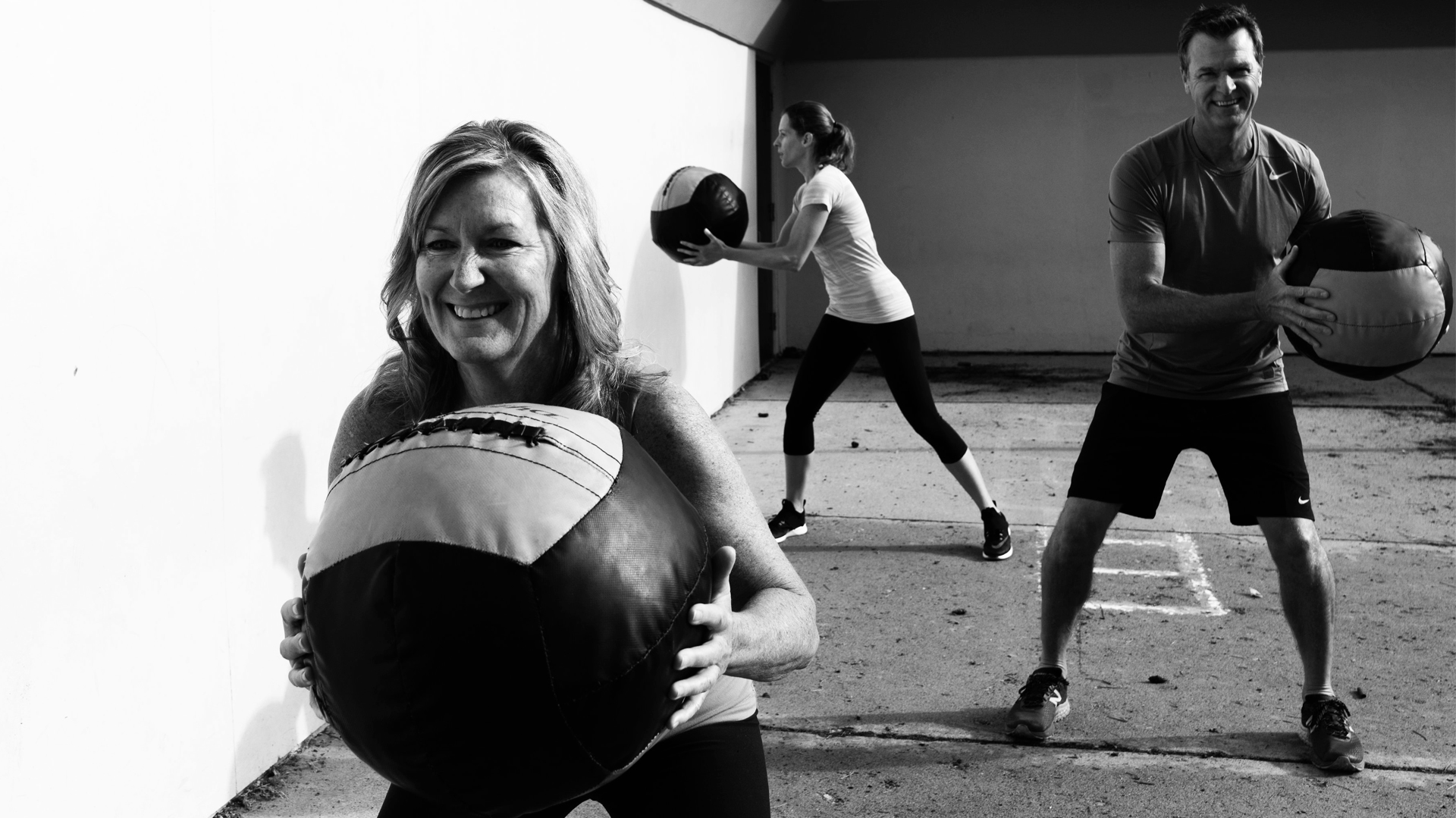 People smiling and exercising at the bootcamp